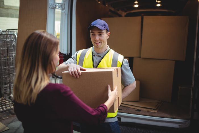 Delivery man delivering a package to a customer on time. 