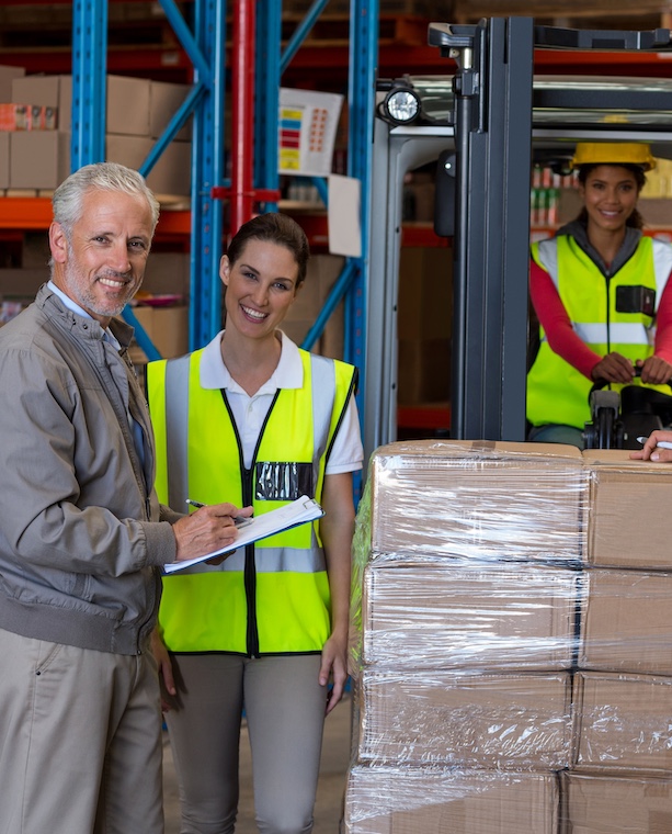 Warehouse manager and workers preparing a shipment