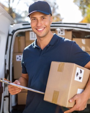 Delivery man standing in front of his van