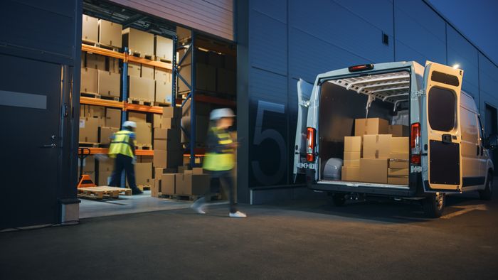 Outside of Logistics Distributions Warehouse Diverse Team of Workers Loading Delivery Truck with Cardboard Boxes.