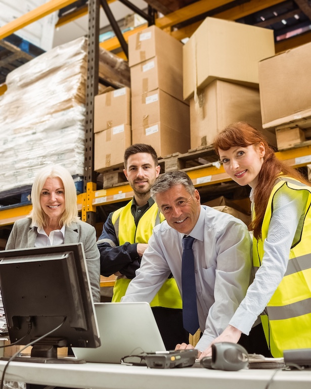 Warehouse team smiling at camera