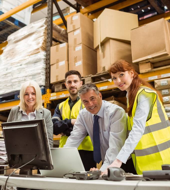 Warehouse team smiling at camera