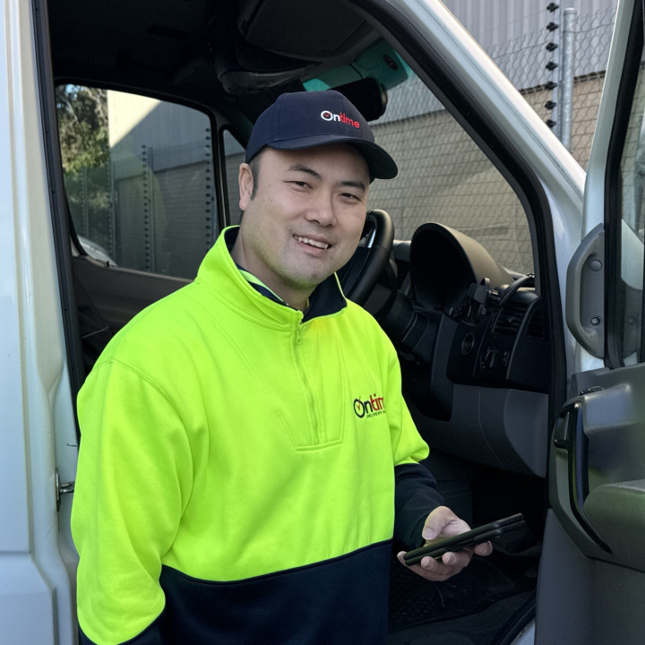 Ontime delivery partner holding a phone.