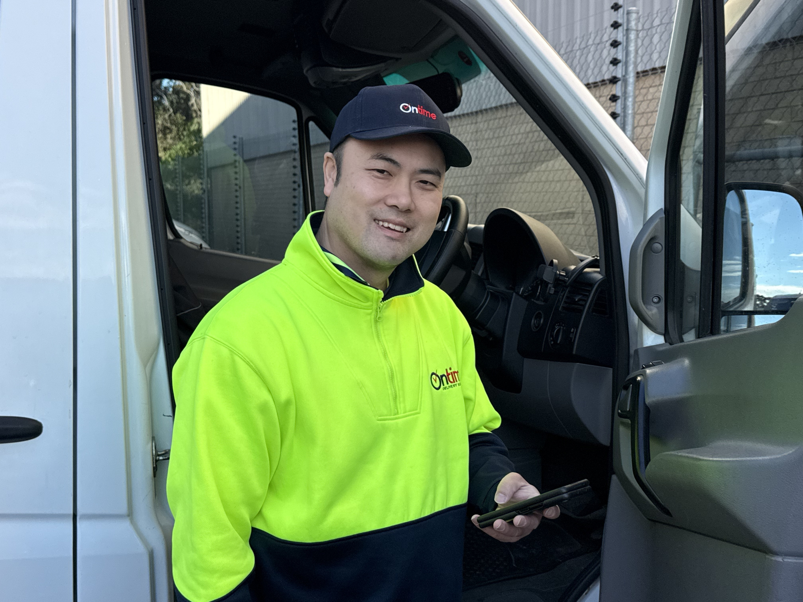Ontime delivery partner holding a phone.